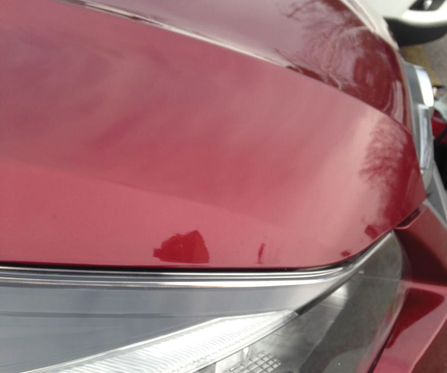 Chipped Red Car after paint fix